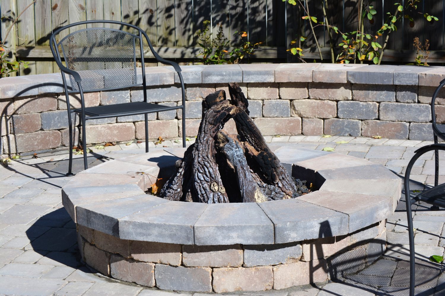 Brick fire pit on a paver patio designed for Indiana cool-season evenings