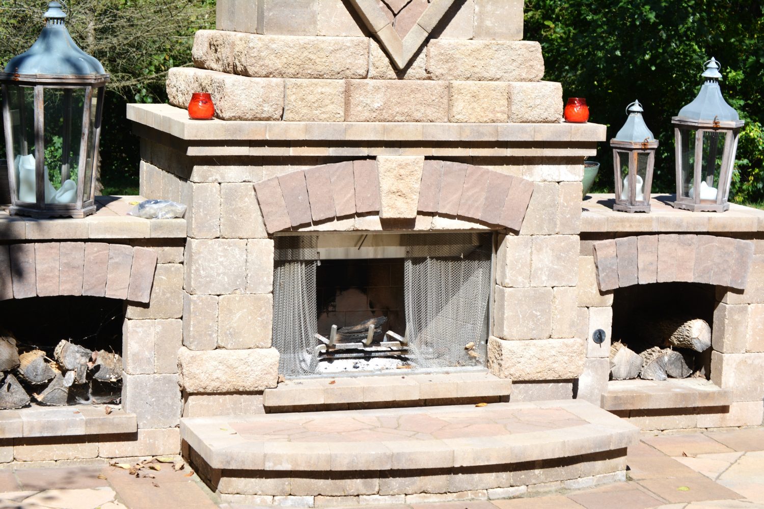 Custom outdoor stone fireplace by Plant Studio Landscape