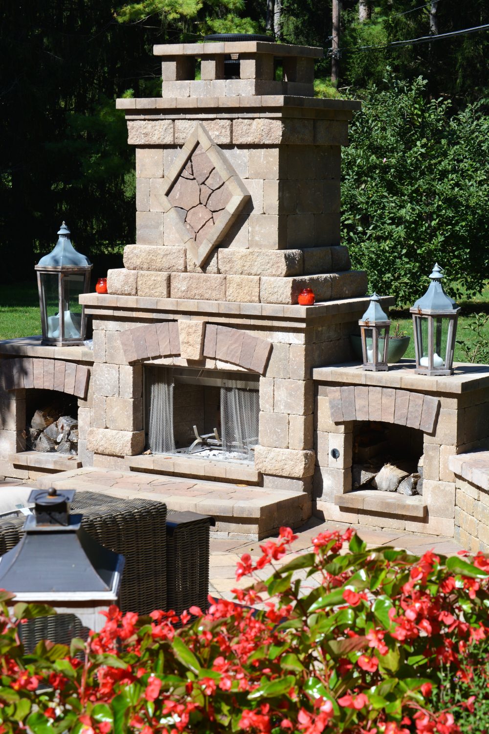 Outdoor custom fireplace with stone embellishment on an Indiana property by Plant Studio Landscape