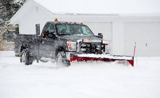 Snow removal in progress on an East Central Indiana commercial property by Plant Studio Landscape